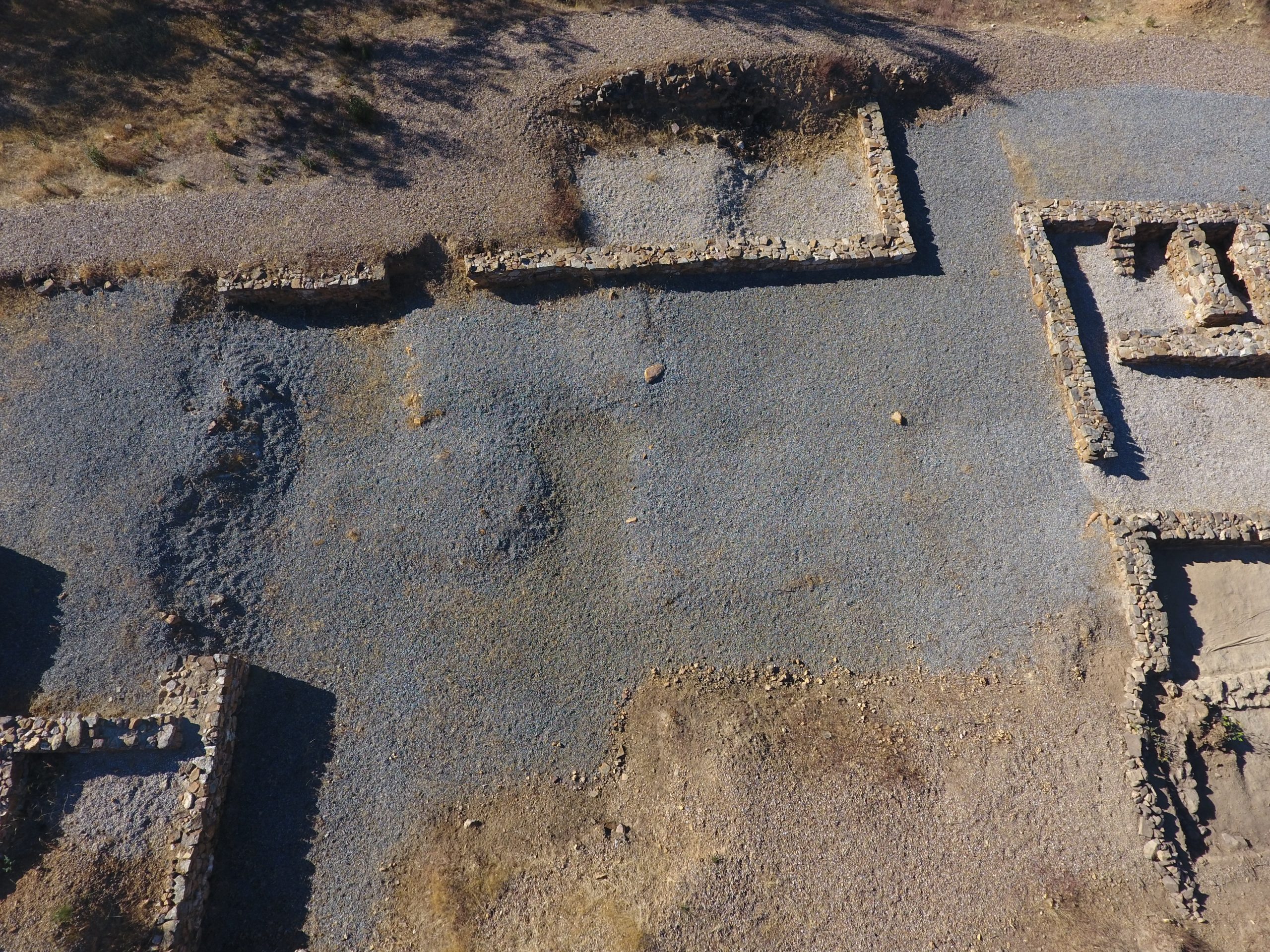 Vista del Sector B del yacimiento arqueológico de Valderrepisa, con estructuras murarias rectangulares y espacios amplios.