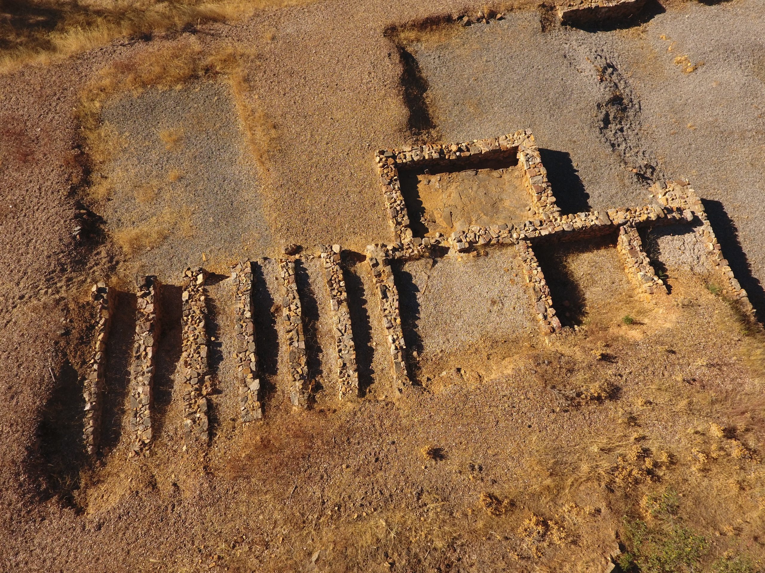 Vista aérea del Sector C del yacimiento arqueológico de Valderrepisa, con estructuras excavadas en hiladas de piedra.